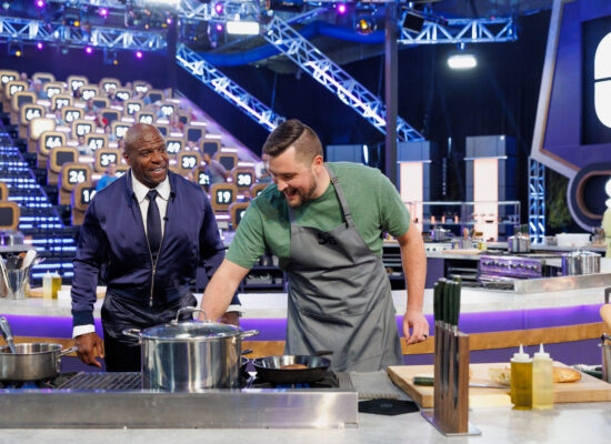 Sofia Lescano 6 Host Terry Crews interacting with #56 - Jeff McCoy during cook, as seen on 100 Cooks, Season 1.