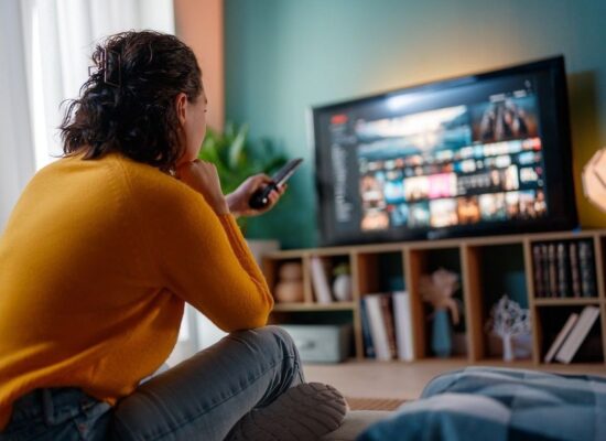 Sofia Lescano 6 Happy woman watching TV at home.